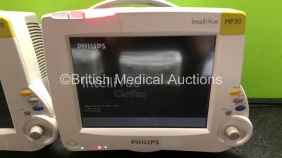 2 x Philips IntelliVue MP30 Patient Monitors (Both Power Up, 1 x Damage to Casing - See Photos) with 2 x Philips IntelliVue X2 Handheld Patient Monitors Including Press, Temp, NBP, SpO2 and ECG/Resp Options with 2 x Batteries (Both Power Up, 1 x Damaged C - 3