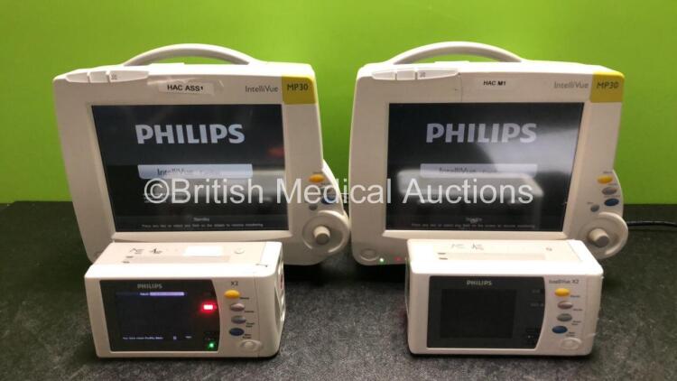 2 x Philips IntelliVue MP30 Patient Monitors (Both Power Up, 1 x Damage to Casing - See Photos) with 2 x Philips IntelliVue X2 Handheld Patient Monitors Including Press, Temp, NBP, SpO2 and ECG/Resp Options with 2 x Batteries (Both Power Up with Damage to