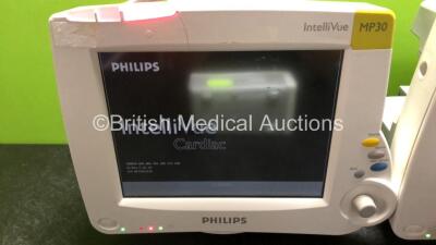 2 x Philips IntelliVue MP30 Patient Monitors (Both Power Up, 1 x Damage to Casing - See Photos) with 2 x Philips IntelliVue X2 Handheld Patient Monitors Including Press, Temp, NBP, SpO2 and ECG/Resp Options with 2 x Batteries (Both Power Up with Damage to - 2