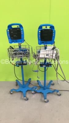 2 x GE Dinamap ProCare Auscultatory 300 Vital Signs Monitors on Stands (Both Power Up - Cracked Casings)