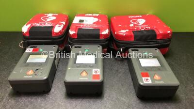 3 x Philips FR3 Heartstart Defibrillators in Carry Cases (All Power Up, Self Test Failed, with Stock Batteries, Stock Batteries Not Included)