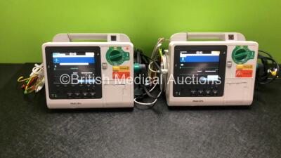 2 x Philips Heartstart XL+ Defibrillators Including Pacer, ECG and Printer Options *Mfd 2014 / 2013* with 2 x Paddle Leads and 2 x Philips ECG Leads (All Power Up)