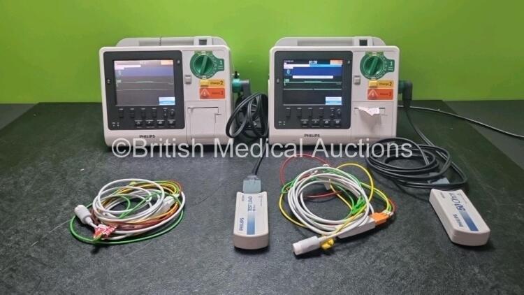 2 x Philips Heartstart XL+ Defibrillators Including ECG and Printer Options with 2 x Paddle Leads, 2 x M3725a Test Loads and 2 x 3 Lead ECG Leads (Both Power Up) *US71514445 / US71514444*