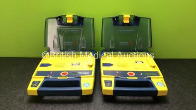 2 x Cardiac Science Powerheart AED G3 Defibrillators with 2 x Powerheart AED G3 Batteries (Both Power Up)