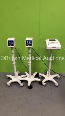 2 x Philips SureSigns VS2+ Patient Monitors on Stands (Both Power Up) and 1 x Philips Avalon FM30 Fetal Monitor on Stand (Powers Up with Blank and Damaged Screen)