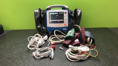 Zoll X Series Monitor/Defibrillator Including ECG, SPO2, NIBP, CO2 and Printer Options with 1 x Sure Power II Battery, 1 x NIBP Cuff and Hose, 1 x 4 Lead ECG Lead, 1 x 6 Lead ECG Lead, 1 x Paddle Lead and 1 x SPO2 Finger Sensor in Carry Bag (Powers Up and