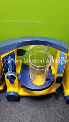 4 x Laerdal LSU Suction Units with 4 x Cups All with Missing Lids (All Power Up, 2 x with Damage to Casing - See Photos) *SN 78120440054 / 78100668687 / 78200441927 / 78120440090* - 3