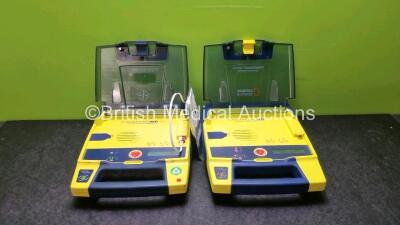 2 x Cardiac Science Powerheart AED G3 Defibrillators with 2 x Powerheart AED G3 Batteries and 1 x Out of Date Electrode Pack (Both Power Up)