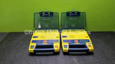 2 x Cardiac Science Powerheart AED G3 Defibrillators with 2 x Powerheart AED G3 Batteries (Both Power Up)