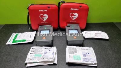 2 x Philips FR3 Heartstart Defibrillators in Carry Cases with 2 x Batteries *Install Before *02-2024 / 06-2027* with 6 x In Electrode Packs 2 x In Date 4 x Out of Date (Both Power Up and Pass Self Test) *SN C18G-01399 / C18G-01370*