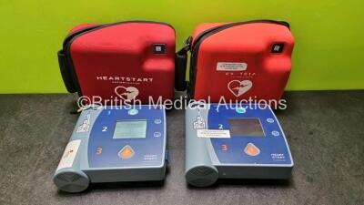 2 x Philips Heartstart FR2+ Defibrillators in Carry Cases with 2 x Philips M386A Batteries *Install Before 12-2020 / 09-2023 (Both Power Up and Pass Self Test) *SN