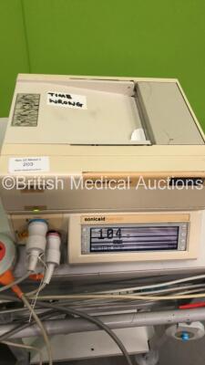 Mixed Lot Including 1 x Sonicaid Team Duo Fetal Monitor on Stand with 2 x Transducers (Powers Up with Damaged Casing-See Photo) 1 x Welch Allyn Spot Vital Sign Monitor on Stand (Powers Up with Damaged Casing-See Photo) 4 x Suction Canisters on Stand (All - 4