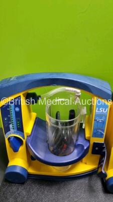 4 x Laerdal LSU Suction Units with 4 x Cups All with Missing Lids (All Power Up, 1 x Damage to Casing - See Photo) *SN 78331076561 / 78130440138 / 72870899409 / 78161071926* - 5