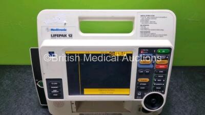 Medtronic Lifepak 12 Biphasic Defibrillator / Monitor Including Pacer, ECG and Printer Options with 3 x Batteries Ref 11141-000106 (Powers Up with Stock Battery, Stock Battery Not Included, Missing Printer - See Photos) - 2