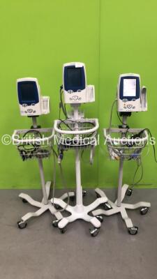 3 x Welch Allyn Spot Vital Signs LXi Patient Monitors on Stands with 2 x AC Power Supplies and 2 x SpO2 Leads/Sensors (All Power Up)