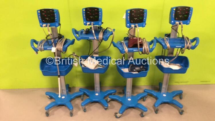 4 x Dinamap V100 Vital Signs Monitors with 4 x SPO2 Finger Sensors, 4 x BP Cuffs and Hoses and 4 x Power Supplies on Stands (All Power Up)