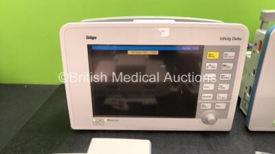 2 x Drager Infinity Delta Patient Monitors Including HemoMed 1, Aux/Hemo 3, MultiMed and NIBP Options with 2 x Drager Infinity Docking Stations and 2 x AC Power Supplies (Both Power Up) *SN 6003180472, 6001388466, 6100972174, 6100972673, MS182840510220333 - 2