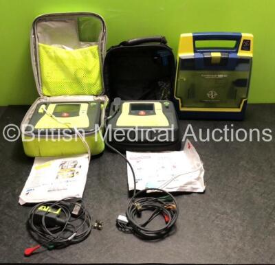 Job Lot Including 2 x Zoll AED PRO Defibrillators with 2 x Batteries, 2 x 3 Lead ECG Leads and 2 x Electrode Packs *Both Expired* (Both Power Up) and 1 x Cardiac Science Powerheart AED G3 Defibrillator (Powers Up with Stock Battery, Battery Not Included) 