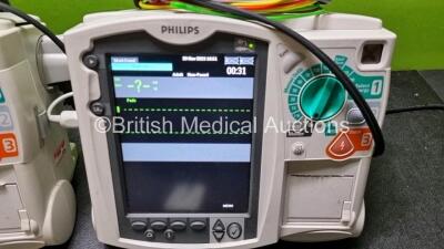 2 x Philips Heartstart MRx Defibrillator / Monitor Including , ECG, and Printer Options, with 2 x M3725A Test Load, 2 x Paddle Leads, 2 x Philips M3539A Module and 1 x Philips M1674A 3 Lead ECG Lead (Both Power Up) *SN US00586636 / US00599185* - 2