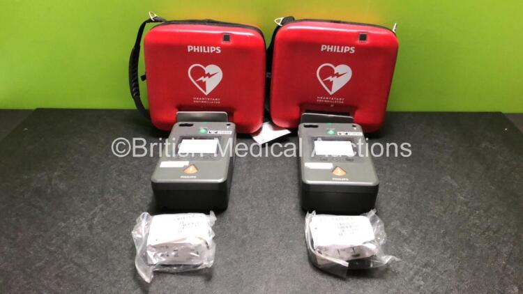 2 x Philips FR3 Heartstart Defibrillators in Carry Cases with 4 x Batteries (Both Power Up and Pass Self Test) *SN C16F-00388 / C12F-00445*