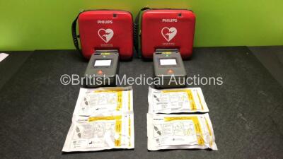 2 x Philips FR3 Heartstart Defibrillators in Carry Cases with 2 x Batteries and 4 x Electrode Packs *All Expire 2023* (Both Power Up and Pass Self Test) *SN C11I-00422 / C11I-00374*