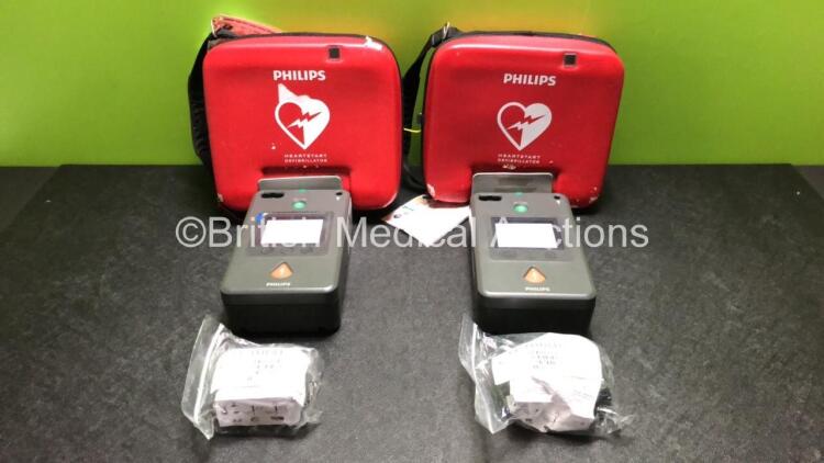 2 x Philips FR3 Heartstart Defibrillators in Carry Cases with 4 x Batteries (Both Power Up and Pass Self Test) *SN C13F-00916 / C12L-00094*