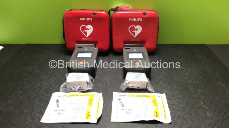 2 x Philips FR3 Heartstart Defibrillators in Carry Cases with 4 x Batteries and 2 x Philips Electrode Packs *Both Expire 2023* (Both Power Up and Pass Self Test) *SN C13F-00917 / C16L-00893*