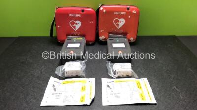 2 x Philips FR3 Heartstart Defibrillators in Carry Cases with 4 x Batteries and 2 x Philips Electrode Packs *Both Expire 2024* (Both Power Up and Pass Self Test) *SN C13F-00936 / C14B-00547*