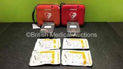 2 x Philips FR3 Heartstart Defibrillators in Carry Cases with 2 x Batteries and 4 x Electrode Packs *All Expire 2023* (Both Power Up and Pass Self Test) *SN C12F-00333 / C18H-00421*