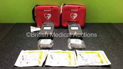 2 x Philips FR3 Heartstart Defibrillators in Carry Cases with 2 x Batteries and 3 x Electrode Packs *All Expire 2023* (Both Power Up and Pass Self Test) *SN C12L-00231 / NA*