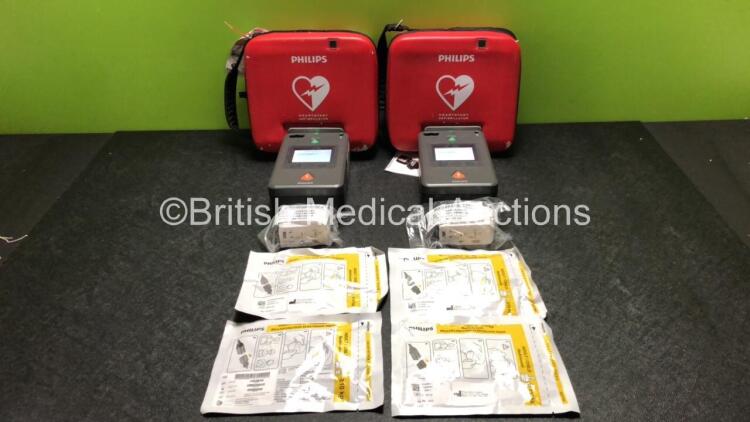 2 x Philips FR3 Heartstart Defibrillators in Carry Cases with 4 x Batteries and 4 x Electrode Packs *All Expire 2023* (Both Power Up and Pass Self Test) *SN C14B-00551 / CL2L-00061*