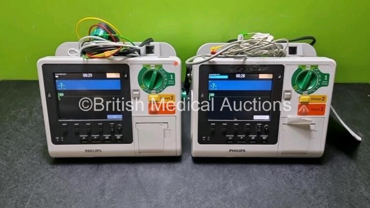 2 x Philips Heartstart XL+ Defibrillators Including PACER, ECG and Printer Options with 2 x Philips M1674A 3 Lead ECG Lead, 2 x Philips Battery Ref 989803167281 and 2 x Paddle Lead (Both Power Up) *SN US4142206 / USN159054*