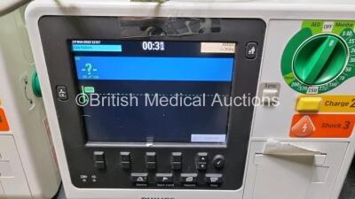 2 x Philips Heartstart XL+ Defibrillators Including PACER, ECG and Printer Options with 2 x Philips M1674A 3 Lead ECG Lead, 2 x Philips Battery Ref 989803167281 and 2 x Paddle Lead (Both Power Up) *SN US4142206 / USN159054* - 2