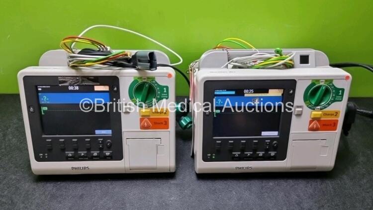 2 x Philips Heartstart XL+ Defibrillators Including PACER, ECG and Printer Options with 2 x Philips M1674A 3 Lead ECG Lead, 2 x Philips Battery Ref 989803167281 and 2 x Paddle Lead (Both Power Up) *SN US41412202 / US51413166*