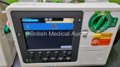 2 x Philips Heartstart XL+ Defibrillators Including PACER, ECG and Printer Options with 2 x Philips M1674A 3 Lead ECG Lead, 2 x Philips Battery Ref 989803167281 and 2 x Paddle Lead (Both Power Up) *SN US41412202 / US51413166* - 3