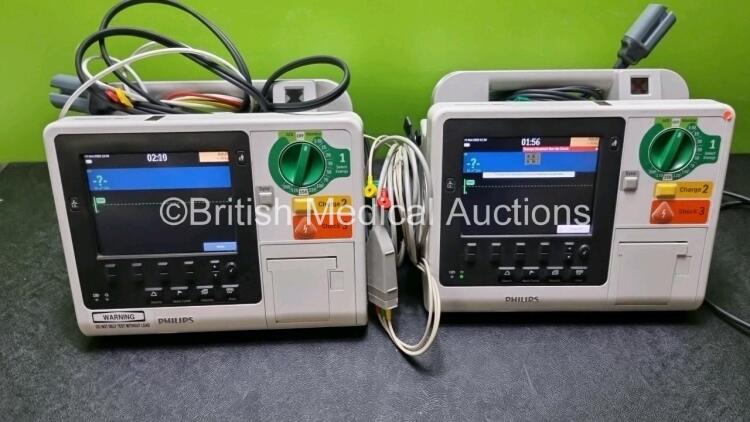 2 x Philips Heartstart XL+ Defibrillators Including , ECG and Printer Options with 2 x Philips M1674A 3 Lead ECG Lead, 1 x Philips Battery Ref 989803167281 and 2 x Paddle Lead (Both Power Up) *SN USD1309137 / US11409767*