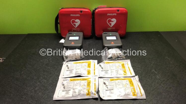 2 x Philips FR3 Heartstart Defibrillators in Carry Cases with 4 x Batteries and 4 x Electrode Packs *All Expire 2024* (Both Power Up and Pass Self Test) *SN C12L-00093 / C14B-00529*