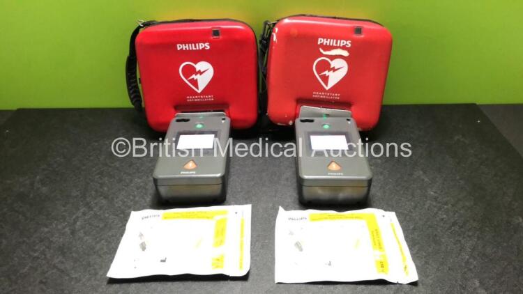 2 x Philips FR3 Heartstart Defibrillators in Carry Cases with 2 x Batteries and 2 x Electrode Packs *Both Expire 2023* (Both Power Up and Pass Self Test) *SN C18B-00275 / C14L-01724*