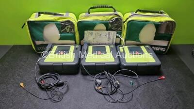 3 x Zoll AED PRO Defibrillators with 3 x Batteries, 2 x 3 Lead ECG Leads, 1 x Out of Date Electrode Pack (All Power Up) *SN AA07B005016 / AA10C016656 / AA09L015767*