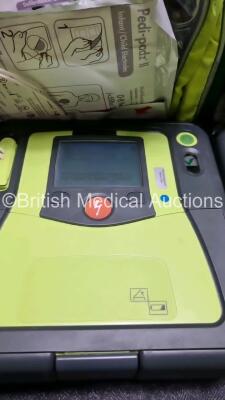 3 x Zoll AED PRO Defibrillators with 3 x Batteries, 2 x 3 Lead ECG Leads 7 x Out of Date Electrode Packs (All Power Up) *SN AA1OC01 / AA05C000333 / AA10C016670* - 4