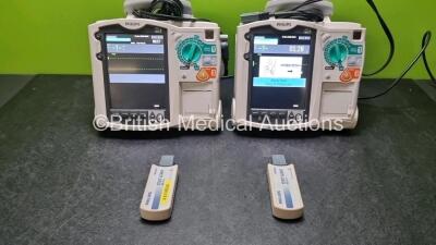 2 x Philips Heartstart MRx Defibrillators / Monitors Including ECG and Printer Options with 2 x Paddle Leads, 2 x Philips M3725A Test Loads and 2 x Philips M3539A Modules (Both Power Up) *SN US00581614 / US00581610*