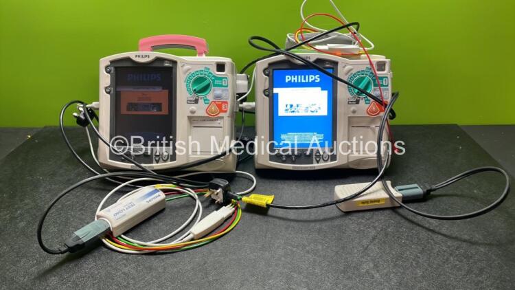 2 x Philips Heartstart MRx Defibrillators Including Pacer ,ECG and Printer Options with 2 x Paddle Leads, 2 x Philips M3725A Test Loads, 2 x 3 Lead ECG Leads, 2 x Philips M3538A Batteries and 2 x Philips M3539A Modules (Both Power Up) *SN US00535031, US00