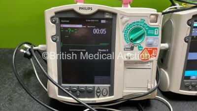 2 x Philips Heartstart MRx Defibrillators Including Pacer ,ECG and Printer Options with 2 x Paddle Leads, 2 x Philips M3725A Test Loads, 2 x 3 Lead ECG Leads, 2 x Philips M3538A Batteries and 2 x Philips M3539A Modules (Both Power Up) *SN US00535031, US00 - 2