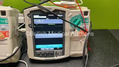 2 x Philips Heartstart MRx Defibrillators Including Pacer ,ECG and Printer Options with 2 x Paddle Leads, 2 x Philips M3725A Test Loads, 2 x 3 Lead ECG Leads, 2 x Philips M3538A Batteries and 2 x Philips M3539A Modules (Both Power Up) *SN US00535031, US00 - 3