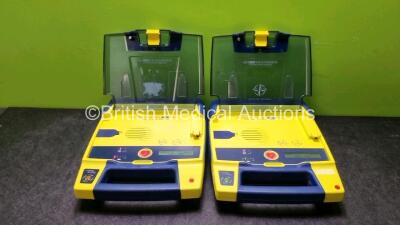 2 x Cardiac Science Powerheart AED G3 Defibrillators with 2 x Powerheart AED G3 Batteries (Both Power Up)