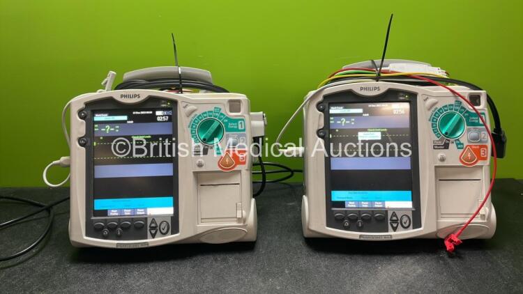 2 x Philips Heartstart MRx Defibrillators Including Pacer ,ECG and Printer Options with 2 x Paddle Leads, 2 x Philips M3725A Test Loads, 2 x 3 Lead ECG Leads, 2 x Philips M3538A Batteries and 2 x Philips M3539A Modules (Both Power Up) *SN US00564938, US00