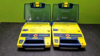 2 x Cardiac Science Powerheart AED G3 Defibrillators with 2 x Powerheart AED G3 Batteries (Both Power Up)