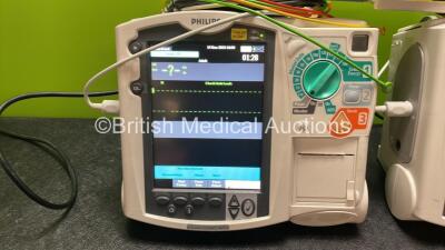 2 x Philips Heartstart MRx Defibrillators Including Pacer ,ECG and Printer Options with 2 x Paddle Leads, 2 x Philips M3725A Test Loads, 2 x 3 Lead ECG Leads, 2 x Philips M3538A Batteries, and 2 x Philips M3539A Modules (Both Power Up) *SN US00585182, US0 - 2