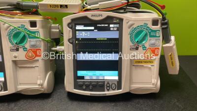 2 x Philips Heartstart MRx Defibrillators Including Pacer ,ECG and Printer Options with 2 x Paddle Leads, 2 x Philips M3725A Test Loads, 2 x 3 Lead ECG Leads, 2 x Philips M3538A Batteries, and 2 x Philips M3539A Modules (Both Power Up) *SN US00585182, US0 - 3