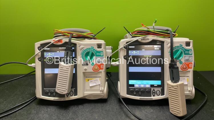 2 x Philips Heartstart MRx Defibrillators Including Pacer ,ECG and Printer Options with 2 x Paddle Leads, 2 x Philips M3725A Test Loads, 2 x 3 Lead ECG Leads, 2 x Philips M3538A Batteries, and 2 x Philips M3539A Modules (Both Power Up) *SN US00579312, US0